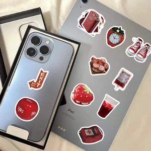 Close-up of cute red aesthetic stickers on blue smartphone and grey tablet for decoration