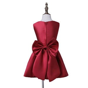 Sleeveless red flower girl dress with a large silk back bow and puffy A-line skirt