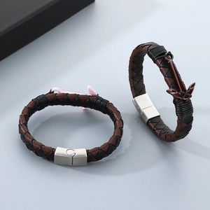 Close-up of woven leather anchor bracelets with magnetic clasps in pink and red finishes
