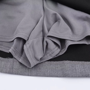 Detail view of double-layer dress with grey knit lining and black outer polyester fabric