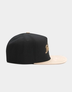 Detailed side view of a Brooklyn hip hop snapback hat with gold 3D letter embroidery