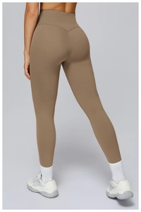 Detail view of high waisted brown yoga pants featuring ergonomic slimming seams on the back