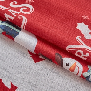 Close-up of thick woven Christmas fabric featuring snowman and snowflake patterns