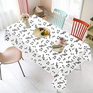Detail showing musical notes print on white disposable tablecloth for party table setting