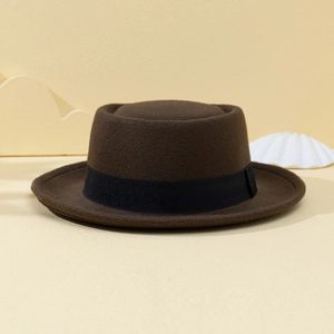 Detailed texture of brown felt pork pie hat with a classic black ribbon band