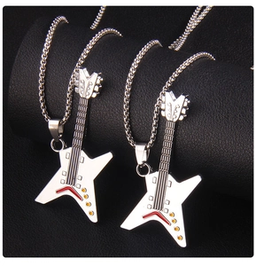 Detailed close-up of silver guitar pendants with red and white enamel on box chains