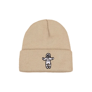 Winter knit beanie in beige with detailed astronaut embroidery on a clean white background