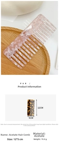 Macro view of a 12x5cm pink acetate hair comb with floral marble pattern and wide teeth