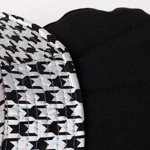 Macro shot of colorful holographic houndstooth PU fabric with metallic reflective finish