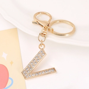 Detailed view of the sparkling gold L letter keychain featuring clear rhinestones