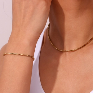 Detail view of a 18K gold-plated stainless steel box chain necklace and bracelet set