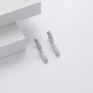 Detailed view of S925 sterling silver huggie earrings with three graduated dangling crystals