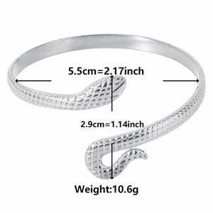Detail view of silver snake-patterned steel cuff with 5.5cm inner diameter measurement
