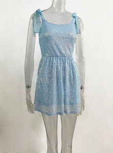 Close-up of light blue sequin dress featuring elegant chiffon shoulder tie-up bows