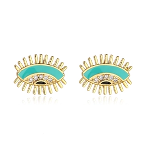 Macro detail of gold-plated evil eye earrings with turquoise enamel and tiny crystals