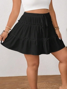 Detailed view of black tiered cake skirt showing elastic high waist and drawstring detail