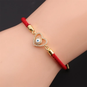 Bracelet en corde tressée rouge avec pendentif cœur œil maléfique doré et zircons
