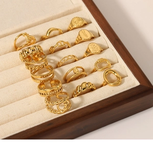 Detailed collection of gold floral and minimalist textured open rings on display stand