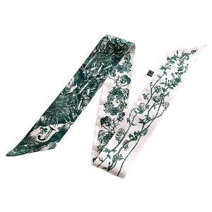 Detail of silk twilly scarf with green Toile de Jouy pattern and letter J print