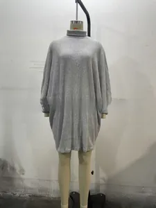 Detail of grey turtleneck knit dress featuring vertical ribbing and batwing sleeves