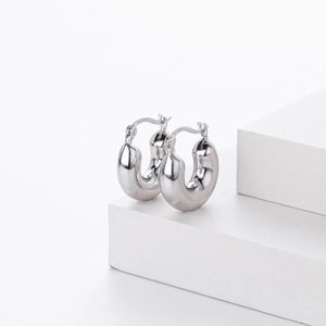 Detailed macro shot showing S925 hallmark on polished sterling silver hoop earrings