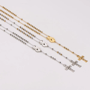 Three gold and silver beaded rosary necklaces with praying hands and cross pendants