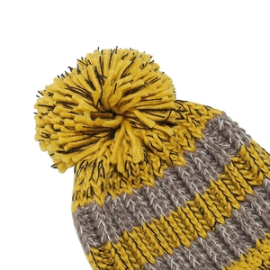 Detail of yellow and grey striped knit hat with thick texture and fluffy top pompom
