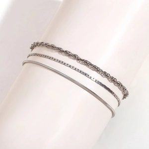 Detailed view of silver layered anklet set with snake, flat square and twisted chain