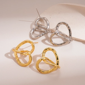 Textured 18k gold and silver irregular heart stud earrings with a hollow twist design