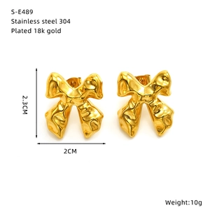 Detailed view of 18k gold plated stainless steel bow earrings with size specifications