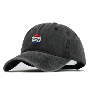 Washed dark grey baseball cap with vintage USA embroidery and curved brim in 45-degree view