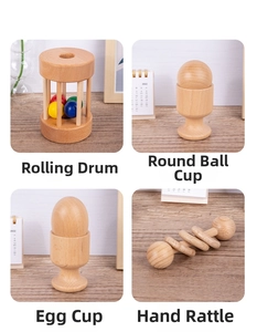 Detailed view of four Montessori wooden baby toys including a rolling drum and rattles