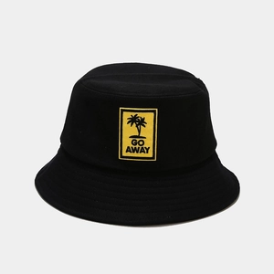 Detail of embroidered yellow patch with palm tree and GO AWAY text on a black bucket hat