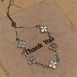 Silver four-leaf clover bracelet with white shell inlay and sparkling pavé accents