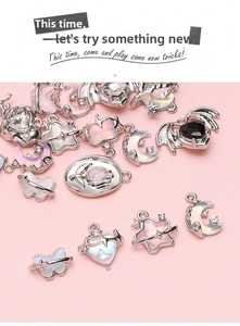 Macro shot of silver alloy pendants with heart, moon and butterfly for DIY jewelry making