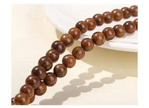 Macro shot of natural golden sandalwood beads with fine wood grain and oily luster