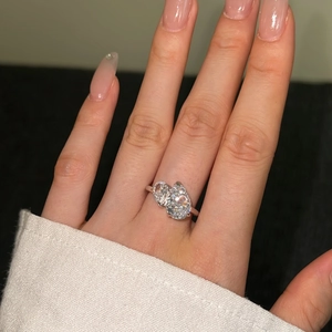 Close-up of S925 silver bypass ring featuring two pear-cut zircon stones on a model's finger