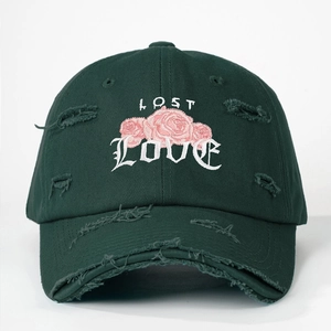 Detail of green distressed baseball cap with rose flower and LOST LOVE embroidery