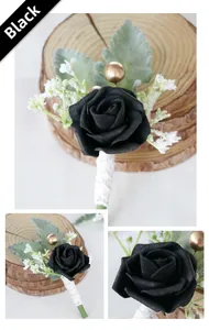 Detail of a handmade black faux rose boutonniere with white baby's breath and green leaves