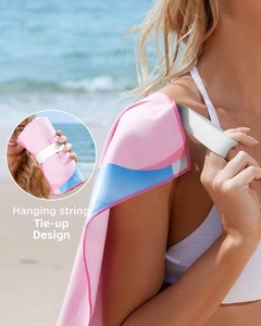 Detail of quick-dry beach towel featuring a pink and blue design and elastic hanging strap
