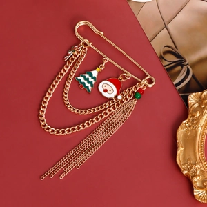 Detailed view of Christmas brooches with Santa, tree charms and gold fringe chains