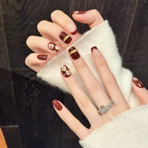 Vintage floral cat eye press-on nails in deep red and gold with 3D embossed flower textures