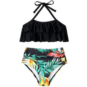 Two-piece girls' swimsuit with black halter ruffle top and tropical print high waist bottoms