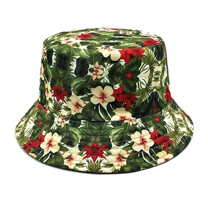 Detailed view of tropical floral print on a cotton bucket hat with vivid leaves and flowers