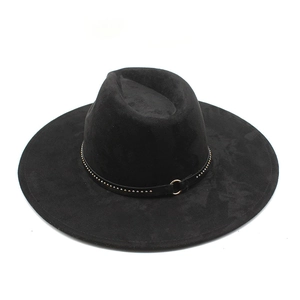 Detail of black suede fedora featuring leather band with gold stud accents and ring buckle