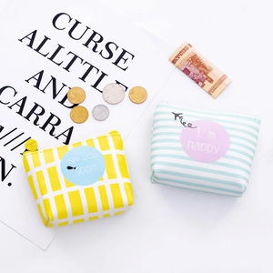 Close-up of compact PU leather coin purses with stripes and plaid patterns