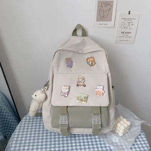 Detail of Korean style canvas backpack with cartoon patches and plush sheep charm