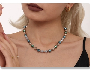 Close-up of multicolor 8mm beaded pearl necklace with blue and green accents on model