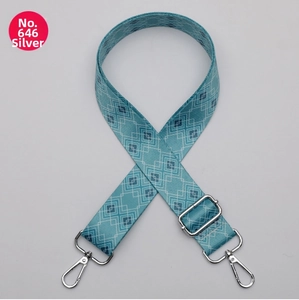 Detail of adjustable 38mm wide woven bag strap with silver hardware and blue diamond pattern