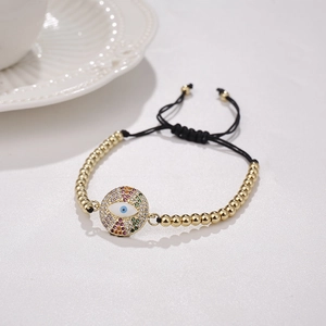 Vergoldetes Perlenarmband mit buntem Evil Eye Anhänger und verstellbarem Textilband